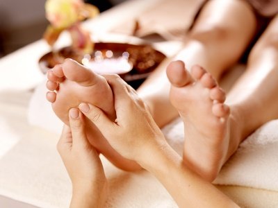 Massage of human foot in spa salon